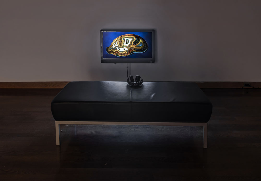 TV mounted low to a wall with an image of a smiling rock for sale on e-bay