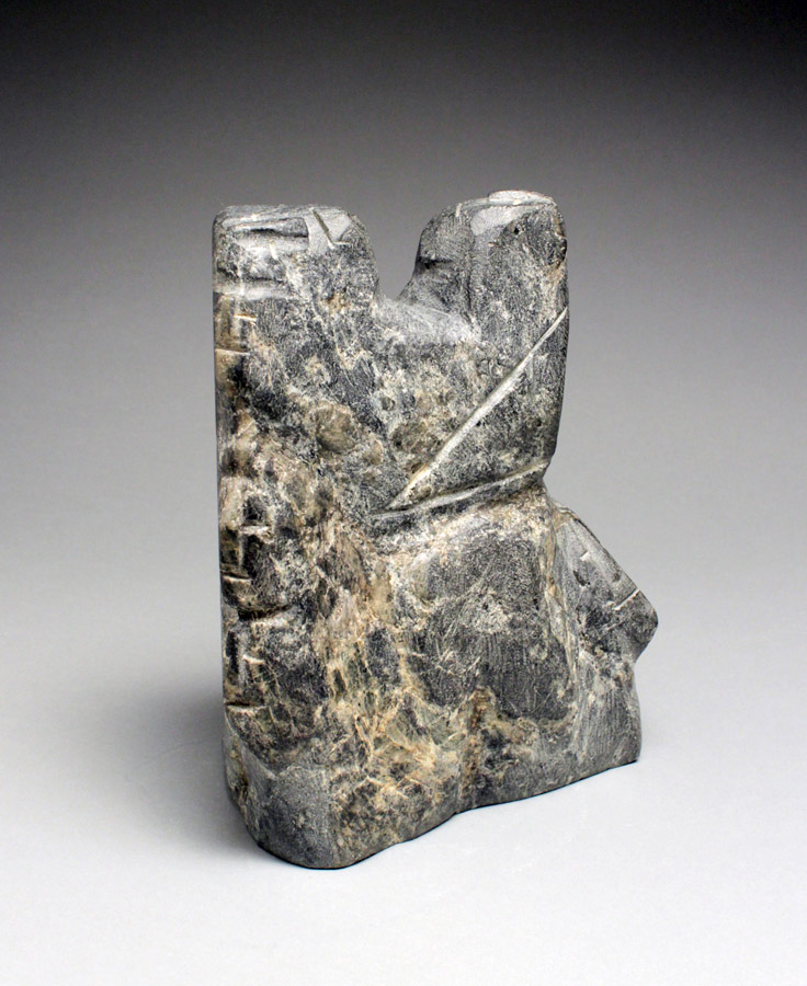 a small grey stone scuptures with minimal embellisments