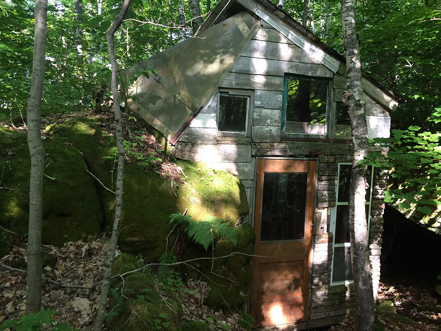 A cabin Galen built with his fathers help when he was fifteen. One of the walls is a boulder, which also acts as the floor for a loft. The walls are ramshackled and the boulder is overgrown with moss.